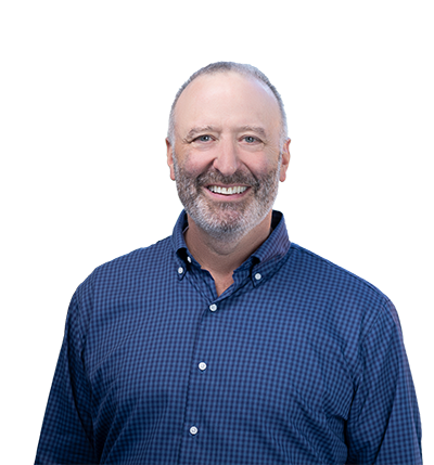 Kevin smiling wearing a blue button up shirt.